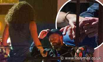 PICTURED: Justin Timberlake and co-star Alisha Wainwright tenderly hold hands in the corner of a bar