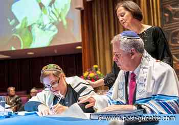 Sacred writing: Members of Temple Sinai take part in scribing a new Torah scroll