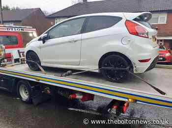 Stolen vehicle taken away for forensic examination