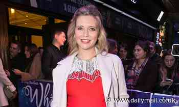 Rachel Riley displays her baby bump in a festive red dress