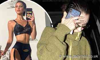 Bella Hadid is uncharacteristically shy as she covers her face in Paris