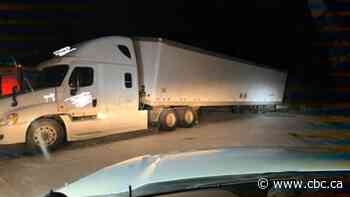 Driver charged after trailer dragged down Highway 11 missing most of its wheels