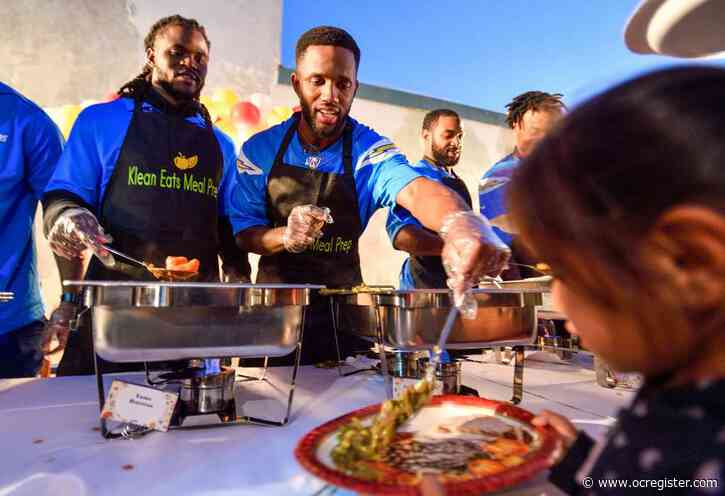 LA Charger’s Casey Hayward brings an early Thanksgiving meal to families at a Santa Ana school