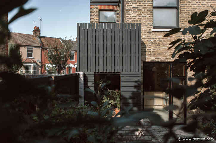 Black-painted larch planks clad extension to a house in London