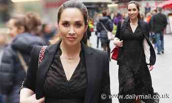 Myleene Klass struts to work in a black tiger print dress and blazer