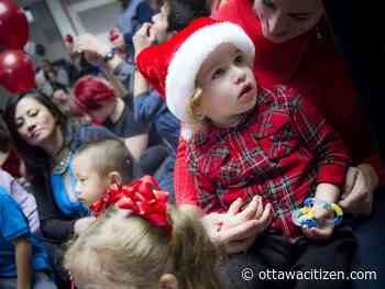 Kids at holiday party enjoy pizza, presents, a visit from Santa — and no judgment