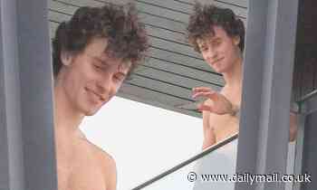 Shawn Mendes greets fans SHIRTLESS from his hotel balcony as he gives them a look at his toned abs