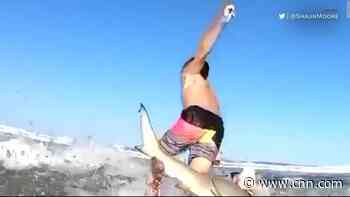 Watch shark knock boy off his surfboard