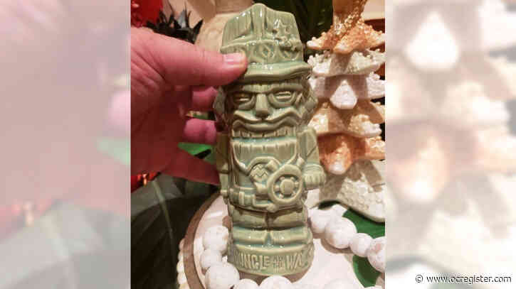 Disneyland fans brave the rain to buy the latest tiki mug from Trader Sam’s