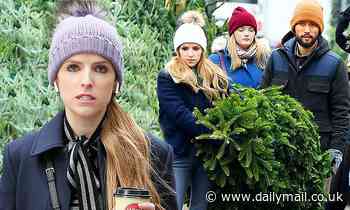 Anna Kendrick lugs around a Christmas tree as she films scenes for her new series Love Life in NYC