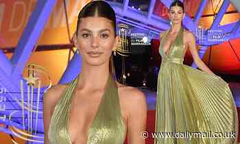 Camila Morrone dazzles in a plunging gold gown at the Marrakech International Film Festival.