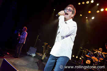 Flashback: Huey Lewis, Garth Brooks Tackle ‘Workin’ for a Livin”