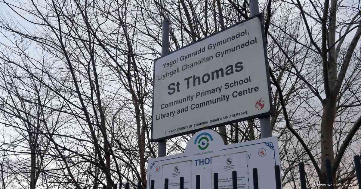 A member of teaching staff has died while at a Swansea primary school