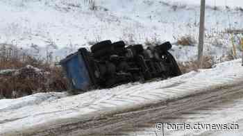 Two dump trucks slide into ditch one after another