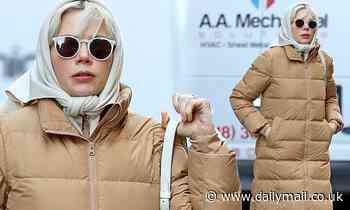 Michelle Williams gets all bundled up in a tan puffer trench coat for her stroll in New York City