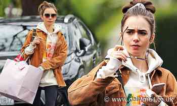 Lily Collins cuts a casual figure in oversize hoodie and jacket