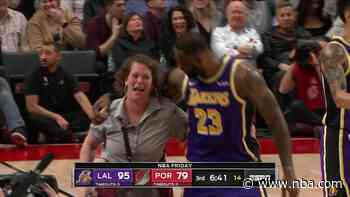 LeBron bumps into court side attendant