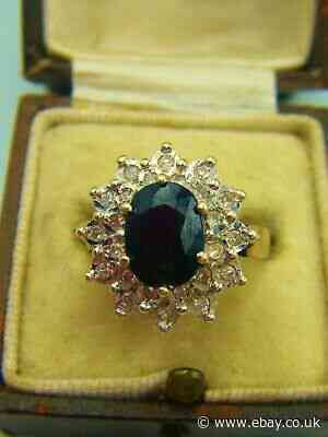 A Dark Sapphire With A Diamond Gallery, Set In Hallmarked 9ct Gold.
