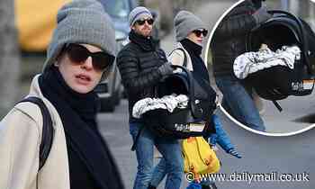 Anne Hathaway emerges with newborn carrier