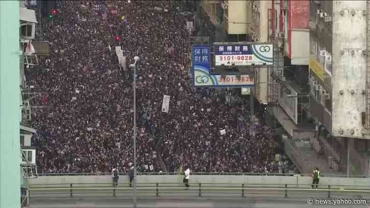 Thousands march in Hong Kong as government urges calm