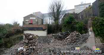 A historic Swansea building has been torn down and reduced to rubble
