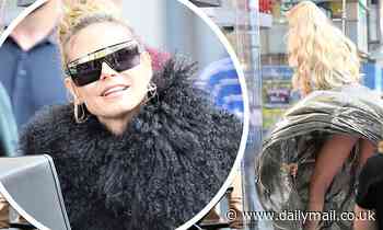 Heidi Klum cuts a VERY glamorous figure as she directs a contestant on Germany's Next Topmodel