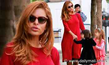 Eva Mendes stands out in bold red dress and slouchy boots