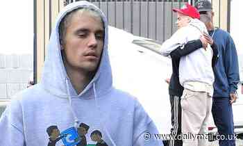 Justin Bieber looks happy to see his friends as he makes his regular visit to the dance studio