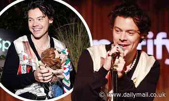 Harry Styles wears a pearl necklace and sports red and black nail varnish at LA event