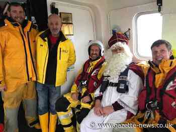 Jolly Father Christmas arrives in Harwich via lifeboat to greet delighted children