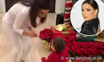 Eva Longoria and her son Santiago get into Christmas as they dance in front of the family's tree 