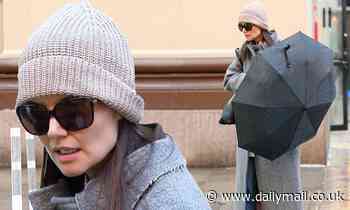 Katie Holmes bundles up in beanie and long coat as she braves rainy NYC weather while hailing cab