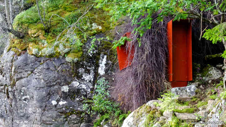 Branches disguise a secluded hideaway next to a Norwegian lake