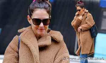 Katie Holmes fends of the winter chill as she picks up some large pieces of art in NYC