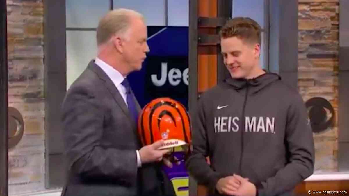 Heisman winner Joe Burrow reacts after receiving a Bengals helmet from former NFL MVP Boomer Esiason