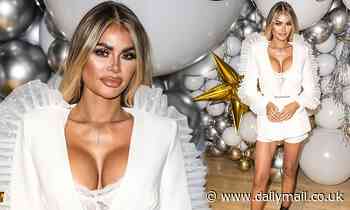 Chloe Sims displays her ample assets in a plunging white blazer with dramatic sheer frills