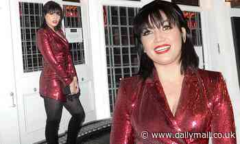 Daisy Lowe puts on a festive display in a shimmering red blazer dress and knee-high boots
