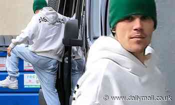 Justin Bieber makes time to warm up with some leg stretches before heading to the dance studio