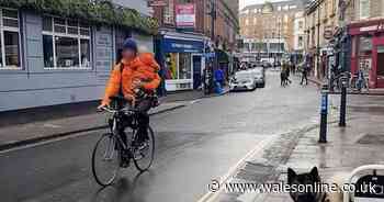 Cyclist slammed for having child on bike - and no helmets