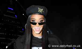 Winnie Harlow displays her quirky style in a beret, fur coat and tracksuit at festival