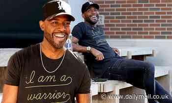 Queer Eye star Karamo Brown flashes a smile as he declares 'I am a warrior' with statement T-shirt