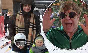 Elton John beams in Burberry scarf as he takes sons, Zachary, eight, and Elijah, six, skiing