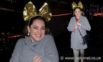 Kelly Brook gets into the festive spirit with GIANT glittery bow as she leaves the radio studios 
