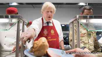 Boris Johnson serves Christmas lunch to British troops stationed in Estonia