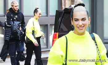 Dua Lipa goes bold in neon green look as she heads out for the holidays with boyfriend Anwar Hadid