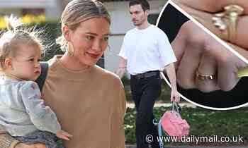 Hilary Duff and husband Matthew Koma flash their wedding bands
