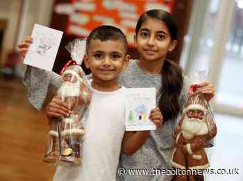 Schoolchildren from St Thomas' CE Halliwell all smiles after winning the popular Design a Christmas Card competition