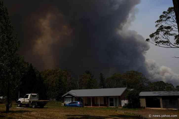 Australian firefighters access badly burned towns; PM defends climate policies