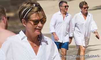 Emma Forbes looks radiant as she strolls on the beach with husband Graham Clempson in Barbados