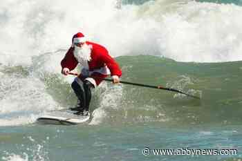 Surfing Santas ride waves along Florida’s Space Coast